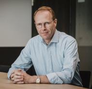 An image of Joan Jørgensen sitting at a desk