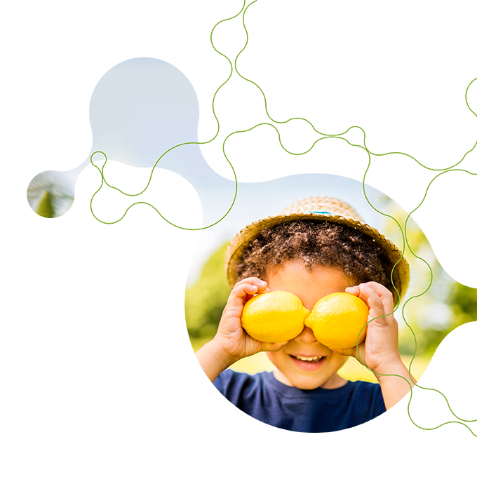 Child playing with lemons