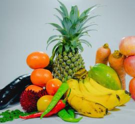 Combination of bananas, pineapple, carrots, mango and other fruits and vegetables